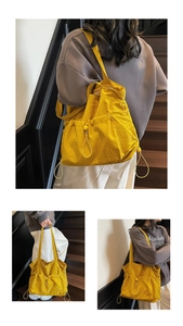 Detail of yellow nylon drawstring tote bag with adjustable side pockets on wooden stairs