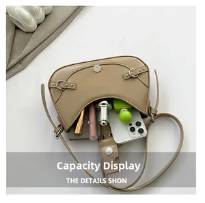 Interior view of khaki crescent bag showing capacity for phone and cosmetics