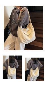 Close-up of a cream canvas crossbody bag featuring multi-pocket design and adjustable strap