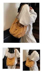 Detail of frayed edges and vintage design on large camel canvas crossbody tote bag