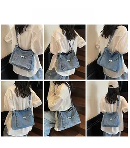 Blue denim crossbody bag featuring chain detail and vintage wash for daily commute