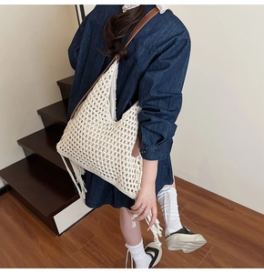 Detail of crochet tote bag featuring long fringes and premium brown leather straps