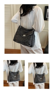 Detailed view of the denim tote with silver twist-lock and chain strap on a model