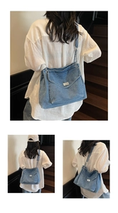 Detail view of denim hobo bag with silver chain strap and metal swivel lock on stairs