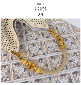 Close-up of woven tote bag with wooden bead handle and vintage lace background