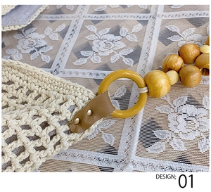Detail of crochet straw bag with wooden bead strap and leather rivet accents