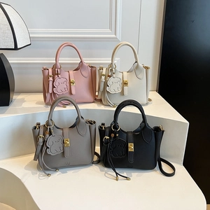 Litchi pattern bucket bags in multiple colors with cute dog charms and gold locks