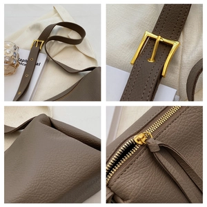 Detailed close-up of taupe litchi leather bag showing gold hardware and stitching