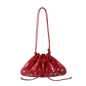 Metallic red drawstring bucket bag with silver studs and polished patent leather finish