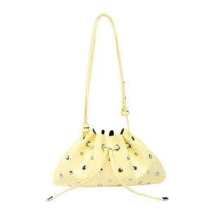 Light yellow leather drawstring bucket bag with silver studs and adjustable strap