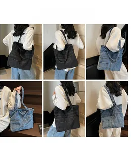 Detail of vintage denim tote bags in grey and blue with reinforced straps and pockets