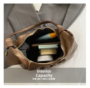 Internal capacity of retro pleated brown hobo bag showing space for phone and makeup