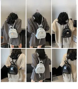 Mini vintage backpacks in black and white displayed from multiple angles by a model