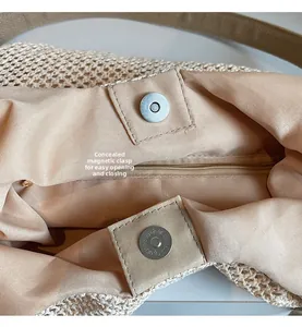 Detail of hand-woven tote bag showing the magnetic buckle and internal zipper pocket
