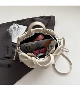 Spacious interior of a pleated cloud tote bag showing storage for a tablet and essentials
