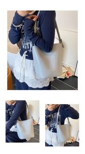 Detailed views of light blue crocodile embossed leather bucket bag with shoulder strap