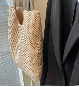 Detailed close-up showing the tight grid weave texture of this beige straw tote bag