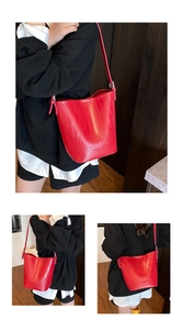 Detailed views of red bucket bag with crocodile texture and adjustable silver buckle straps