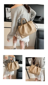 Close-up of beige pleated cloud tote bag showing soft leather texture and crossbody strap