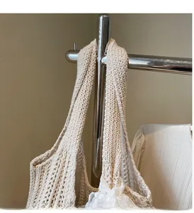 Detailed view of cream-white knitted tote bag with thick cotton woven texture and handle