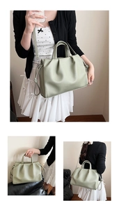 Detail view of light green pleated tote bag featuring soft texture and detachable strap