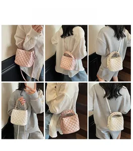 Quilted bucket bag detail showing diamond stitching and metal studs in pink and beige