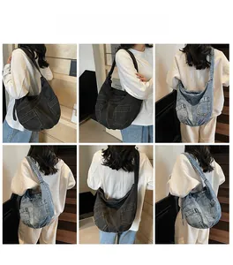 Views of large denim crossbody bags in dark gray and light blue with utility pockets