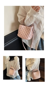 Detail of pink quilted handbag with sparkling rhinestones and woven top handle strap