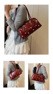 Detail of red vintage leather handbag with pearl and metal star stud decorations