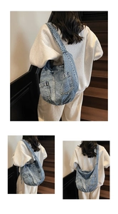 Detailed close-up of blue denim crossbody bag featuring vintage wash and pocket details