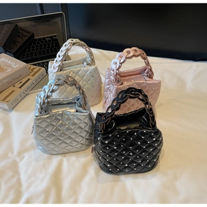 Detail of four mini diamond quilted handbags in silver, black, pink, and white colors