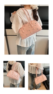 Detail of pink faux leather shoulder bag with decorative pearls and silver star charms