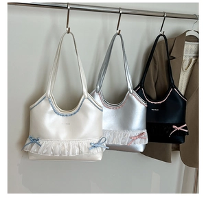 Detail of shoulder bags featuring elegant ruffles, bow accents and shiny metallic finish