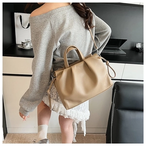 Chic khaki pleated bucket bag styled with round handle and detachable shoulder strap