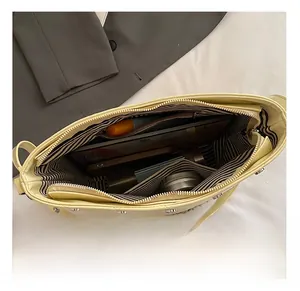 Top view showing large interior capacity of beige bucket bag with striped lining