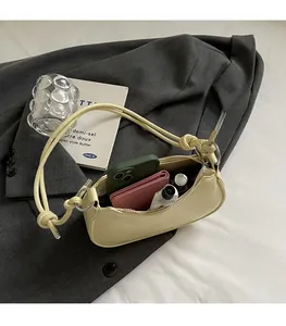 Spacious interior of beige dumpling bag showing storage for phone and wallet