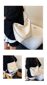 Detail of white quilted bucket bag with silver chain strap and metal rivet accents