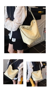 Detail of quilted creamy white bucket bag showing glossy texture and silver chain strap