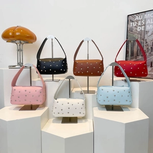 Fashionable baguette shoulder bags with silver studs shown in six vibrant color options