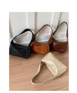 Detailed close-up of retro rivet shoulder bags in four colors on a wood floor