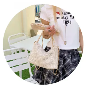 Close-up of beige straw woven bag featuring a stylish bow and gold metal chain strap