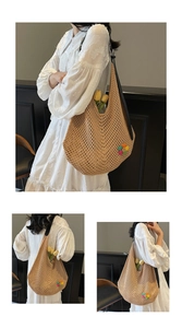 Close-up of woven straw tote bag featuring colorful flower patch and black leather handles