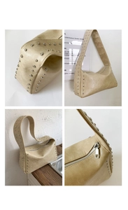 Detail der beigen Schultertasche aus Kunstleder mit Silbernieten und Reißverschluss