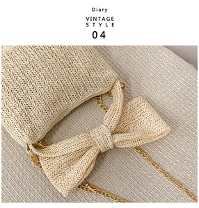 Detail of straw tote bag with V-shaped weave, oversized bow, and gold chain strap