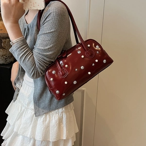 Deep red patent leather underarm bag with vintage metal stud and pearl embellishments