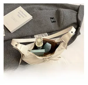 Nahaufnahme des Innenraums mit Kosmetika in der gewebten Hobo-Tasche mit Schleife