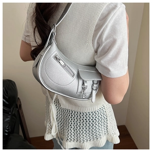 Detail of silver crescent shoulder bag with lychee texture and Y2K metallic finish