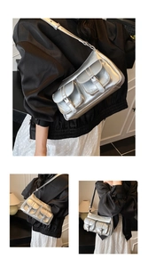 Dettaglio della borsa argento metallizzato con design multi-tasche e fibbie punk
