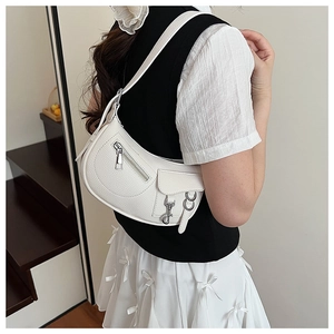 Detailed view of white lychee textured crescent shoulder bag with silver zipper and side pocket