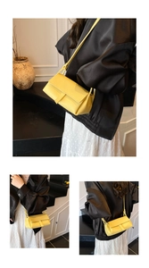 Detailed view of the yellow lychee grain pillow bag with stylish shoulder strap and flap